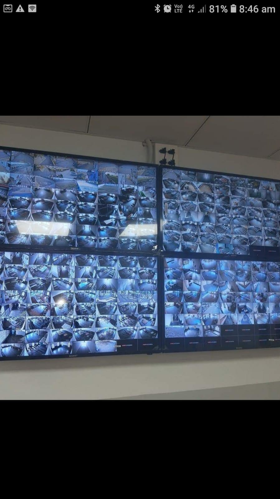 Multiple CCTV monitoring screens displaying live surveillance feeds